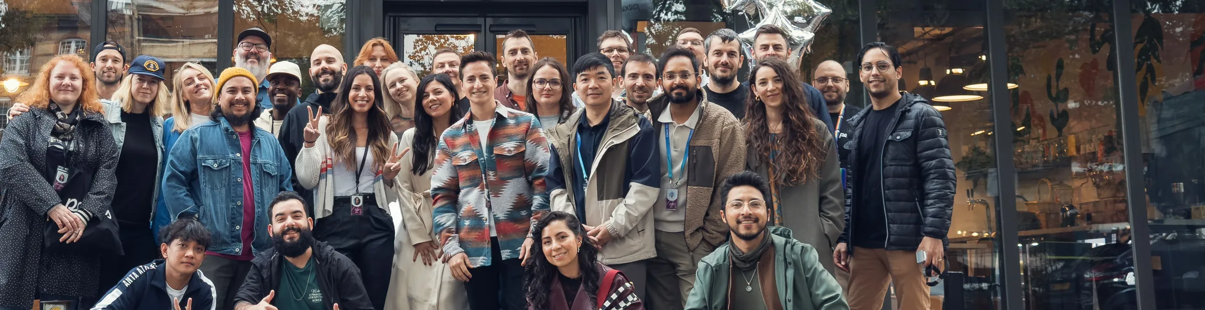 A company team gathered outside their office