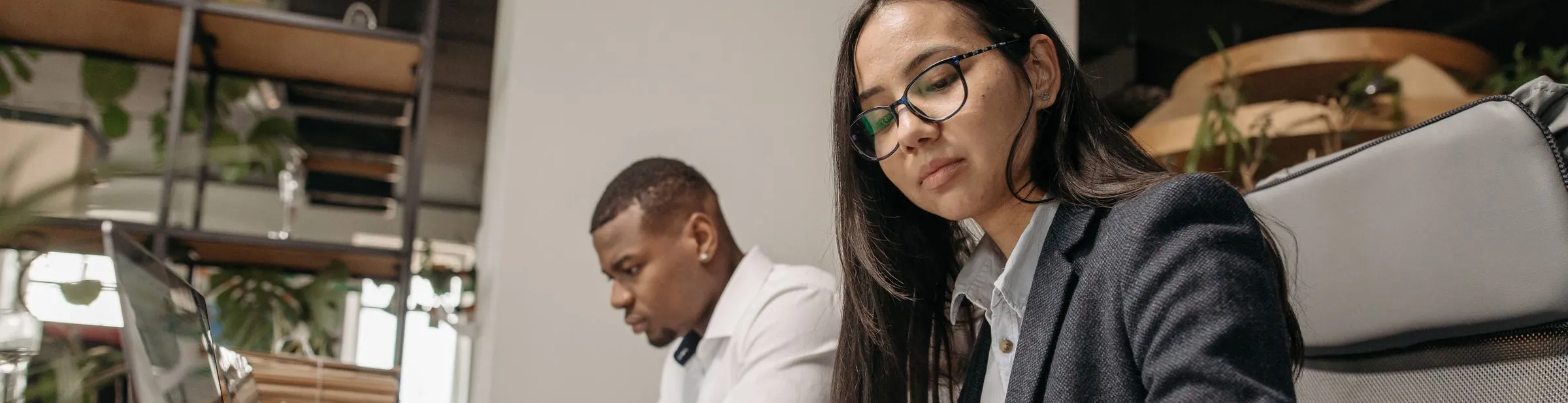 Two colleagues working through the accounts at a desk