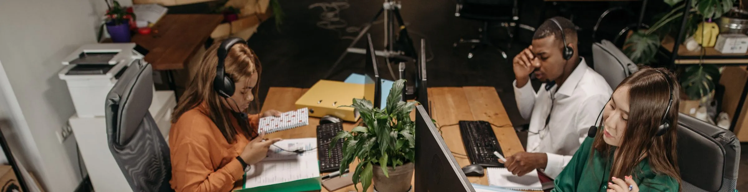 An office team at their computers around a shared desk