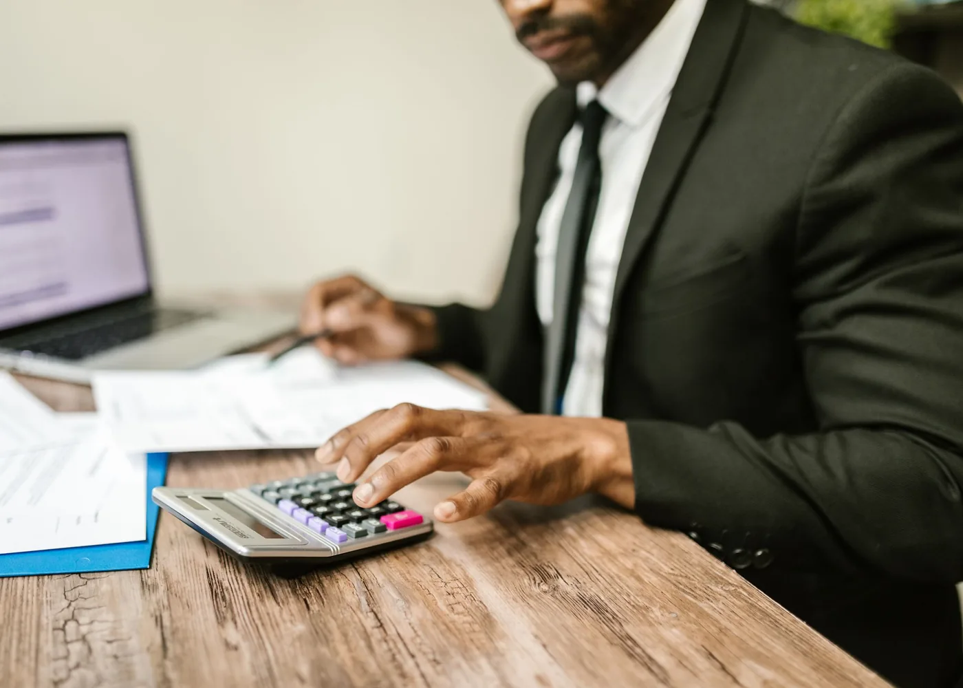Working through the accounts with a calculator and a laptop