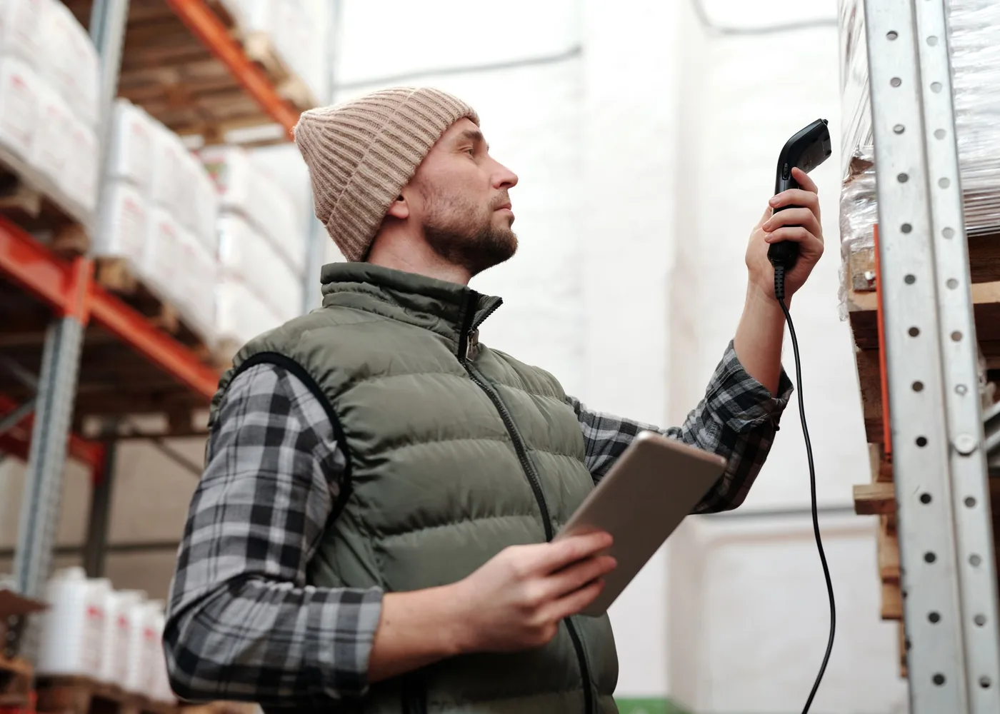 A warehouse worker scanning stock on the racking