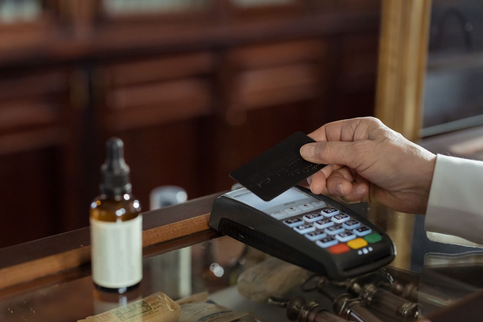 Customer paying by card at a pharmacy counter